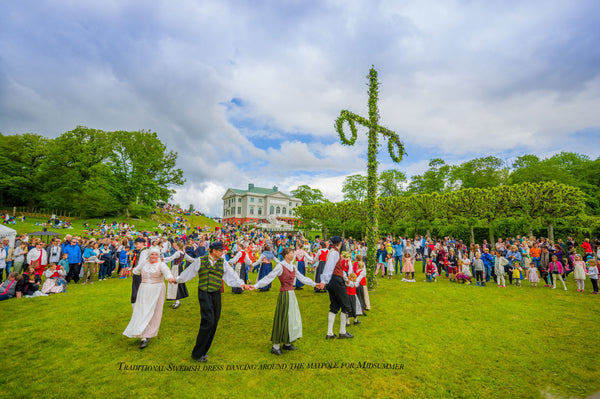 Traditional Swedish dress dancing around the maypole for Midsummer